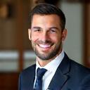 Professional male stylist smiling confidently.